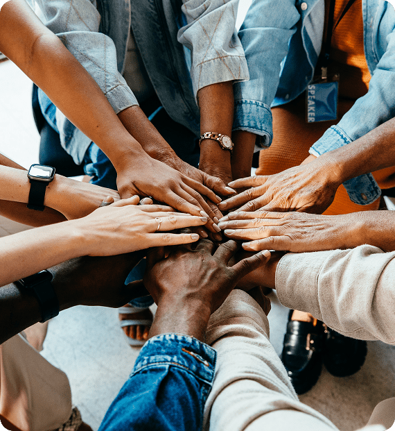 Hands of diverse people joined together.