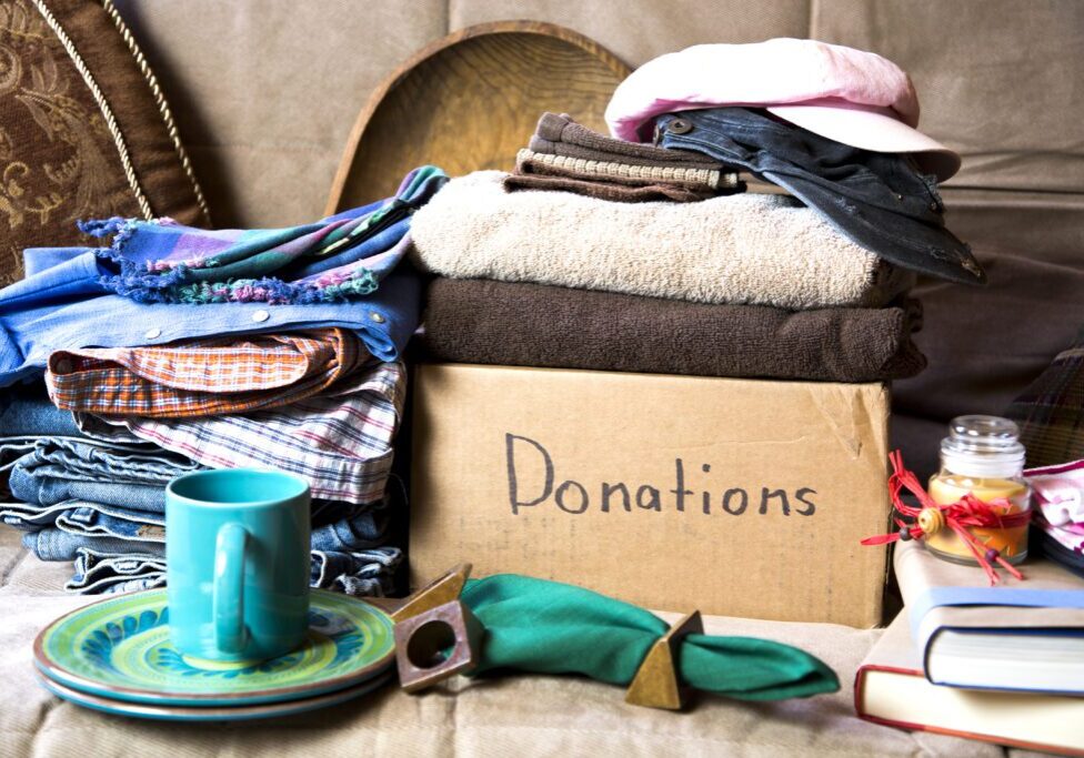 Cardboard box with clothes and donation items.